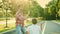 Boy and man dancing in park. Joyful father and son giving high five outdoors