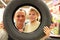 Boy and man look into vehicle tire