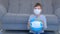 Boy in mask holding globe in mask in hands, coronavirus pandemic and quarantine.