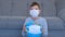 Boy in mask holding globe in mask in hands, pandemic and quarantine.