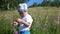 Boy in a meadow catching butterflies with a net. A hot Sunny day. Entertainment in the fresh air