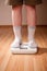 Boy measures weight on floor scales