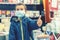 Boy in medical mask at bookstore. young boy chooses books in a bookshop. boy wear a protective mask In a bookstore