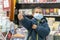 Boy in medical mask at bookstore. young boy chooses books in a bookshop. boy wear a protective mask In a bookstore. Concept of