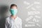 Boy in the medical mask covered his face next to the name of diseases on gray background