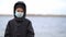 Boy medical mask on his face during quarantine stands on beach during the second wave quarantine coronavirus COVID-19