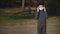 Boy in medical mask during quarantine emotionally removes it from face for breathing fresh air near pine forest