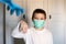 Boy in medical mask throws up a medical glove and smiles