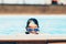 Boy in mirrored sunglasses relaxing in pool