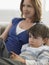 Boy And Mother Watching TV At Home