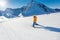 Boy in motion on ski-track skiing view from back