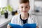 Boy with notebook studying biology at school