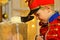 A boy in a nutcracker costume plays with the mouse symbol of the year.