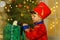 A boy in a nutcracker costume plays with the mouse symbol of the year.