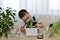 The boy observes the growth of planted hyacinth bulbs. He leaned over the flower and tries to look inside from the side