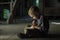 A boy in an old house reading a mysterious book.