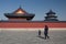 A boy and an old woman passing by the Temple of Heaven in Beijing