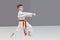 A boy with an orange belt is beating blow hand
