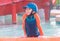 Boy in orange and blue suit is swimming in a water park pool