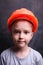Boy in orange building protective helmet