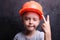 Boy in orange building protective helmet