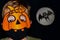 Boy in orange pumpkin and medical mask.Moon reflector with bat silhouette on dark background