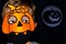 Boy in orange pumpkin and medical mask.Moon reflector with pumpkin silhouette on dark background