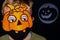 Boy in orange pumpkin and medical mask.Moon reflector with pumpkin silhouette on dark background