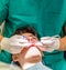 Boy and orthodontist inserting blue ligatures