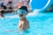 Boy in an outdoor pool at a tropical resort.