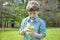 Boy outside picking flowers