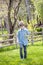 Boy outside picking flowers