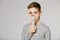 Boy over grey background breathing through inhalator mask