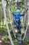 Boy overcoming hanging ropes obstacle in adventure park