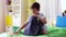 Boy packing schoolbag with school supplies at home