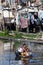 Boy paddling along Paranaque River Philippines