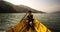 Boy paddling yellow canoe