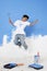 Boy with paint roller jumping in the air. Conceptual image