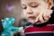 Boy painting ceramic figure