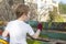 Boy painting fence in garden