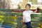 Boy painting fence in garden