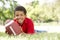 Boy In Park With American Football