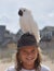 Boy With Parrot on Head at the Beach