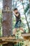 Boy passing cable route in extreme adventure rope park