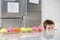 Boy Peaking Over Counter At Row Of Cupcakes