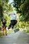 Boy performs a trick on a skateboard while the girl sits and watches