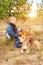 Boy with pet on the autumn forest glade