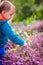 Boy picking up Loosestrife flowers