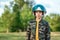 A boy in a pilot`s helmet on a background of greenery. Dream concept, choice of profession, game. Copy space