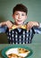 Boy with pizza plate on blue background